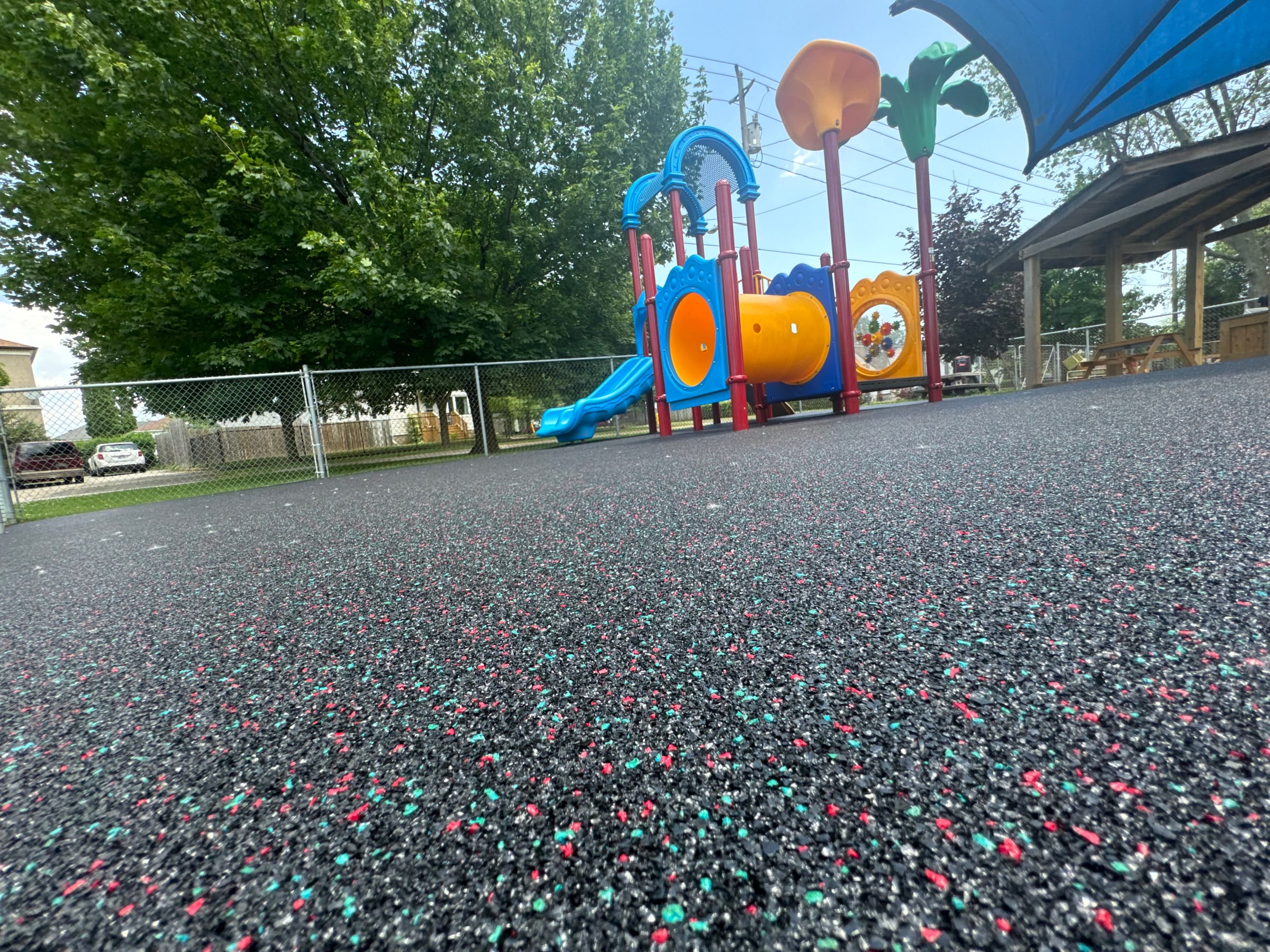 Playground with blue, red, and black rubber surfacing