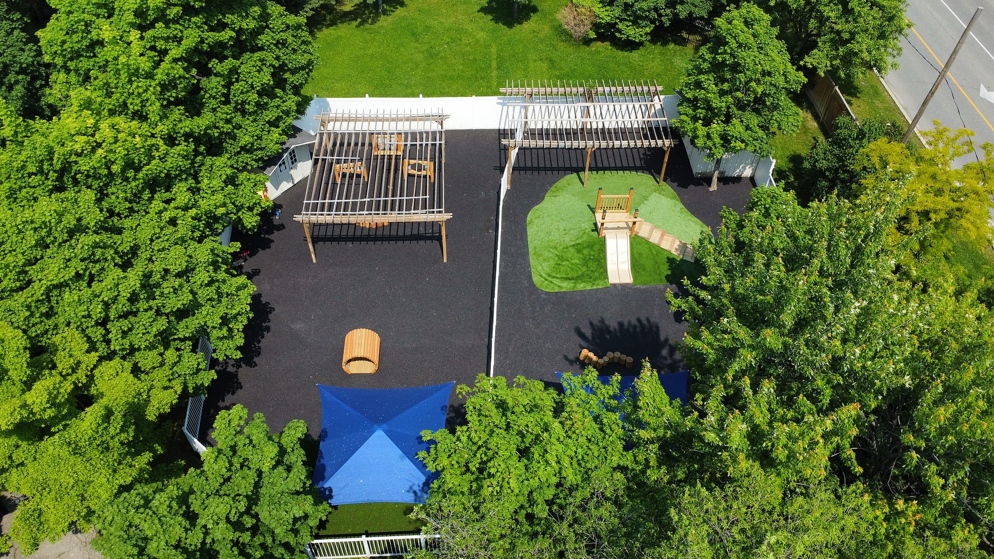 daycare yard artificial turf shade sails rubber surfacing