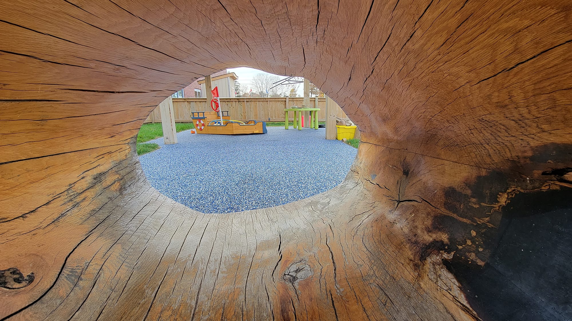 log tunnel natural playground rubber surfacing