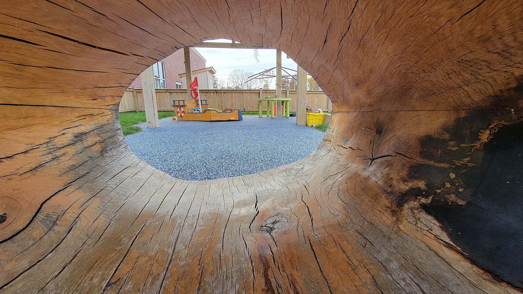 wood log tunnel playground rubber surfacing view