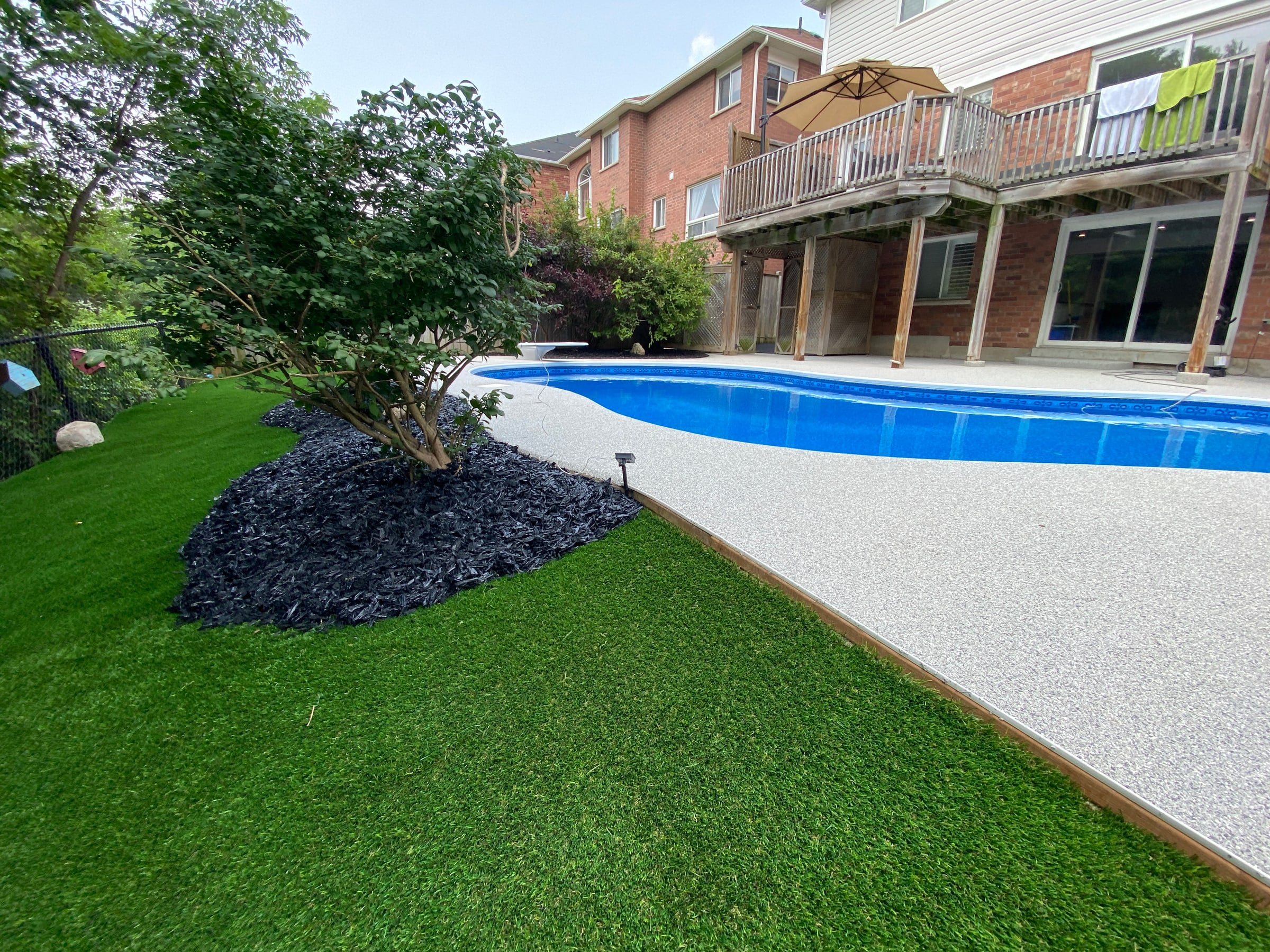 Artificial turf and rubber mulch pool area