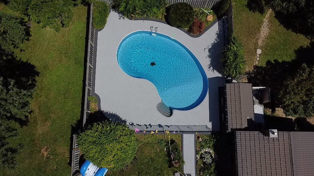 Backyard grey rubber pool deck