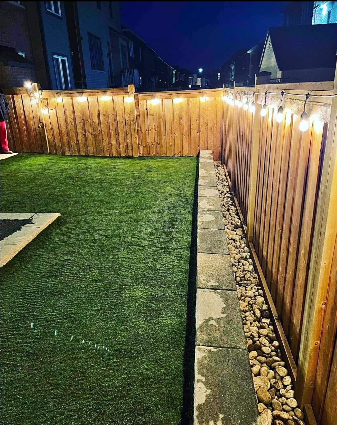 Backyard artificial turf at night