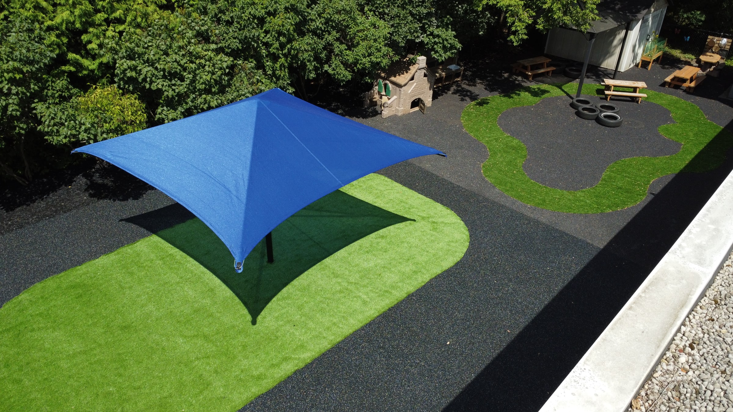 Blue sun shade paired with rubber surfacing