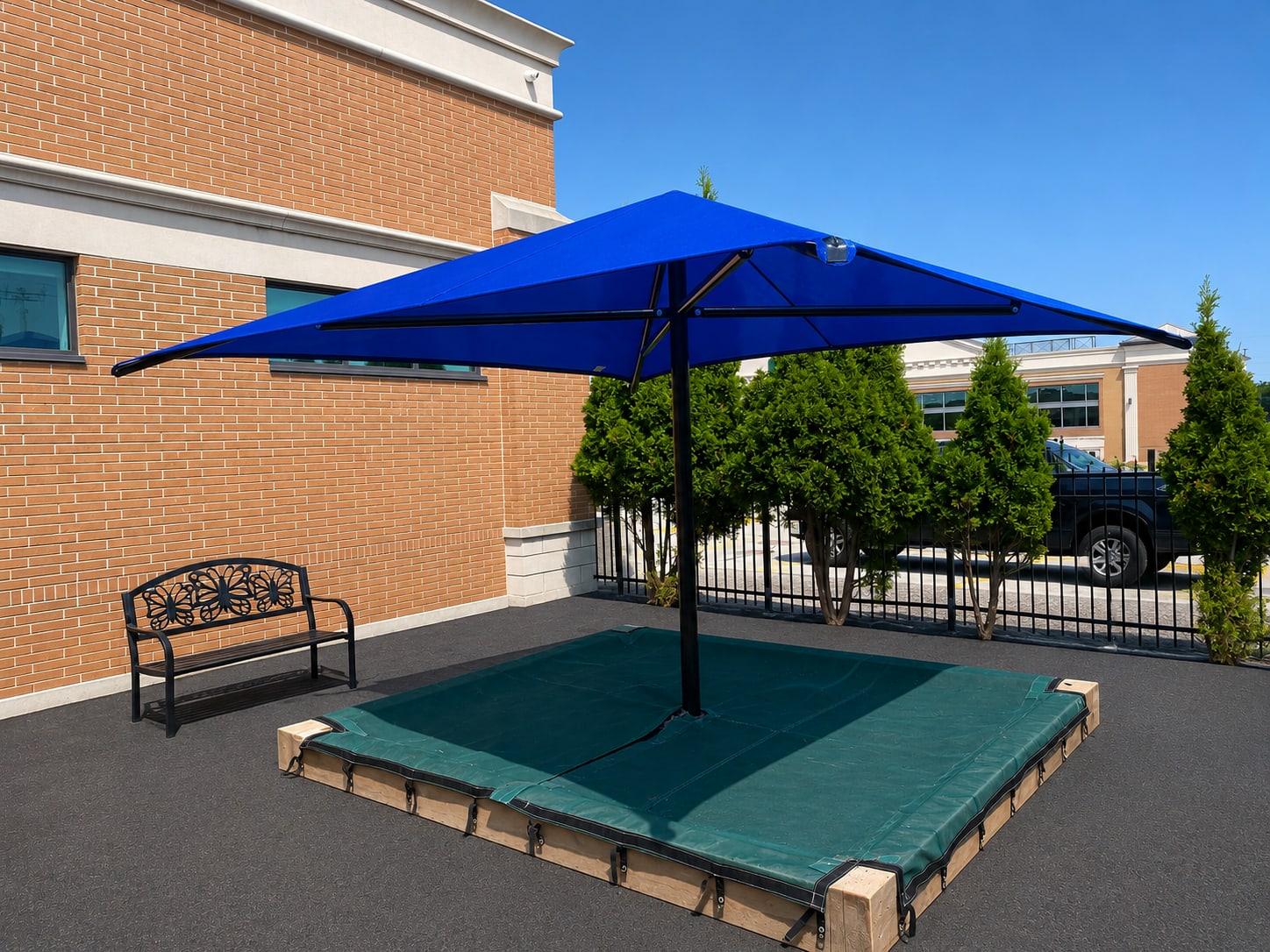 Blue sun shade over a daycare sandbox