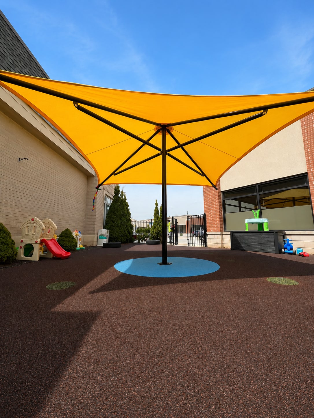 Yellow sun shade for a daycare by Rubberscape